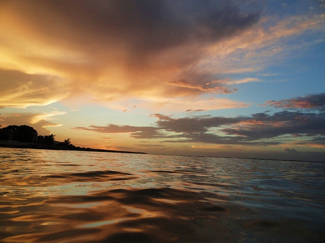 Ocean waves at sunset in Runaway Bay, Jamaica.