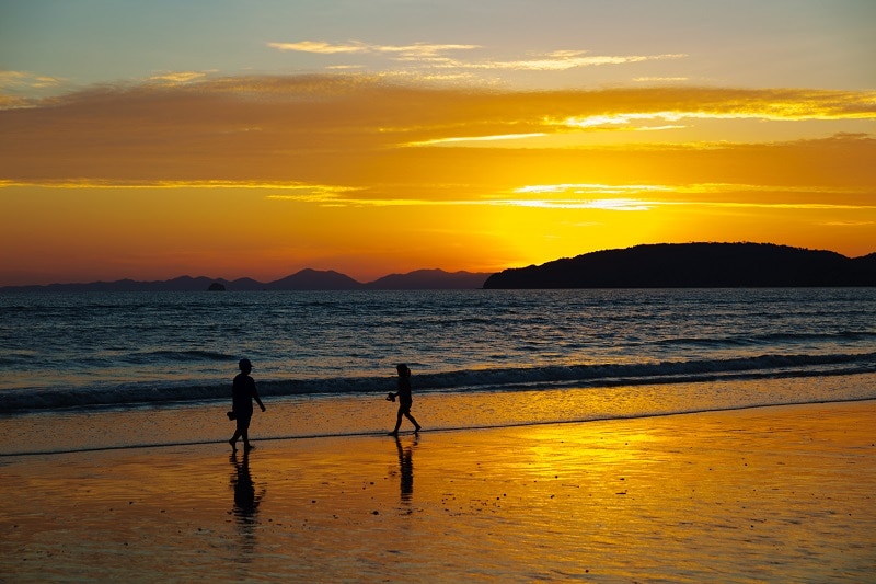 Children Walking At Beach During Sunset