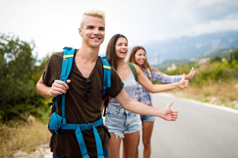 Happy hipster company of friends traveling around world