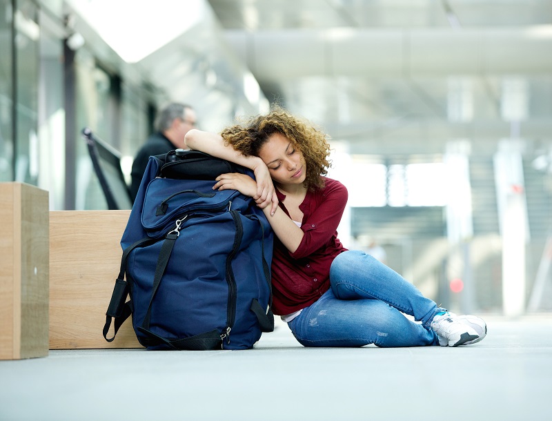 Young woman sleeping at airport