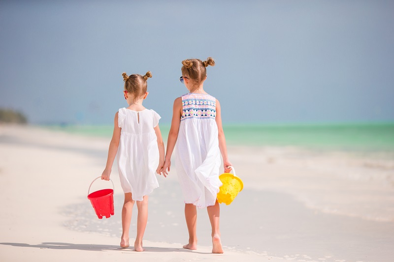 Adorable little girls during summer vacation. Kids enjoy their travel