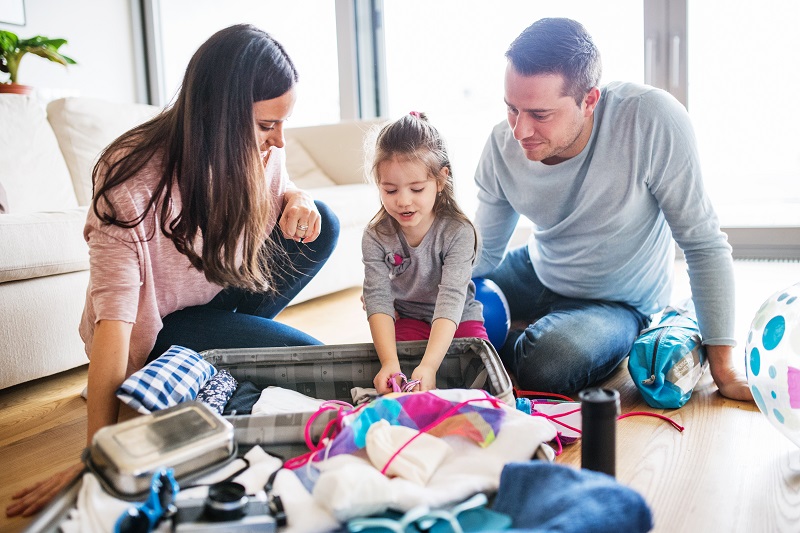 Young family with a child packing for holiday.