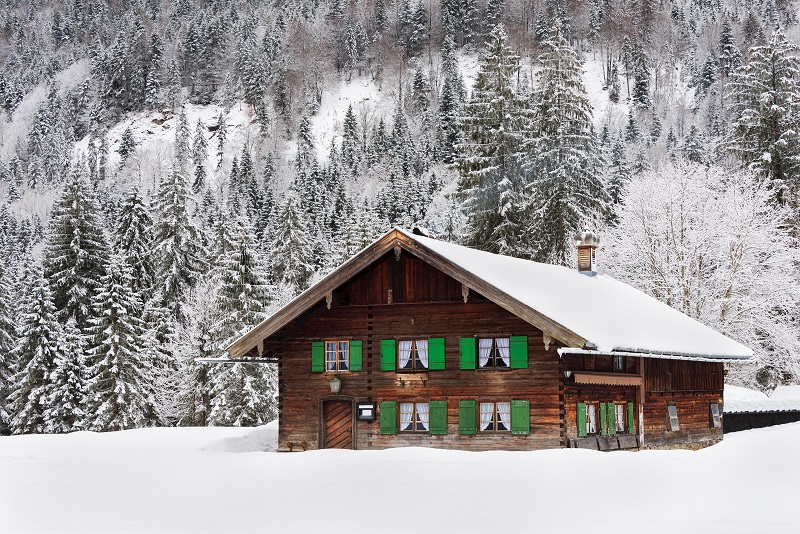 Wooden house in Bavaria in the snow