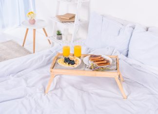 breakfast in bed on wooden tray at morning