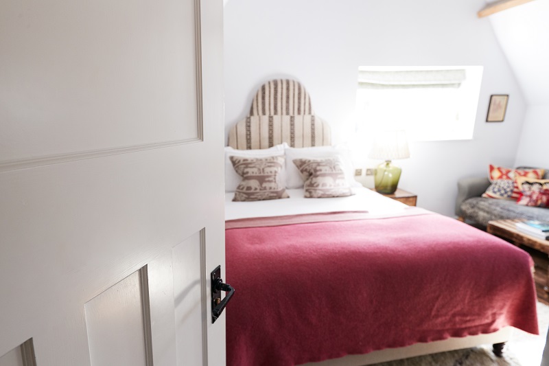 Interior Of Guest Room In Bed And Breakfast Hotel Viewed Through Door