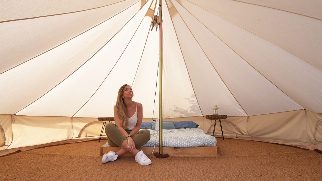 Young woman on the interior of a camping tent