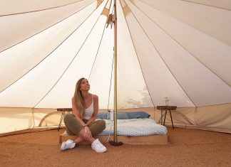 Young woman on the interior of a camping tent