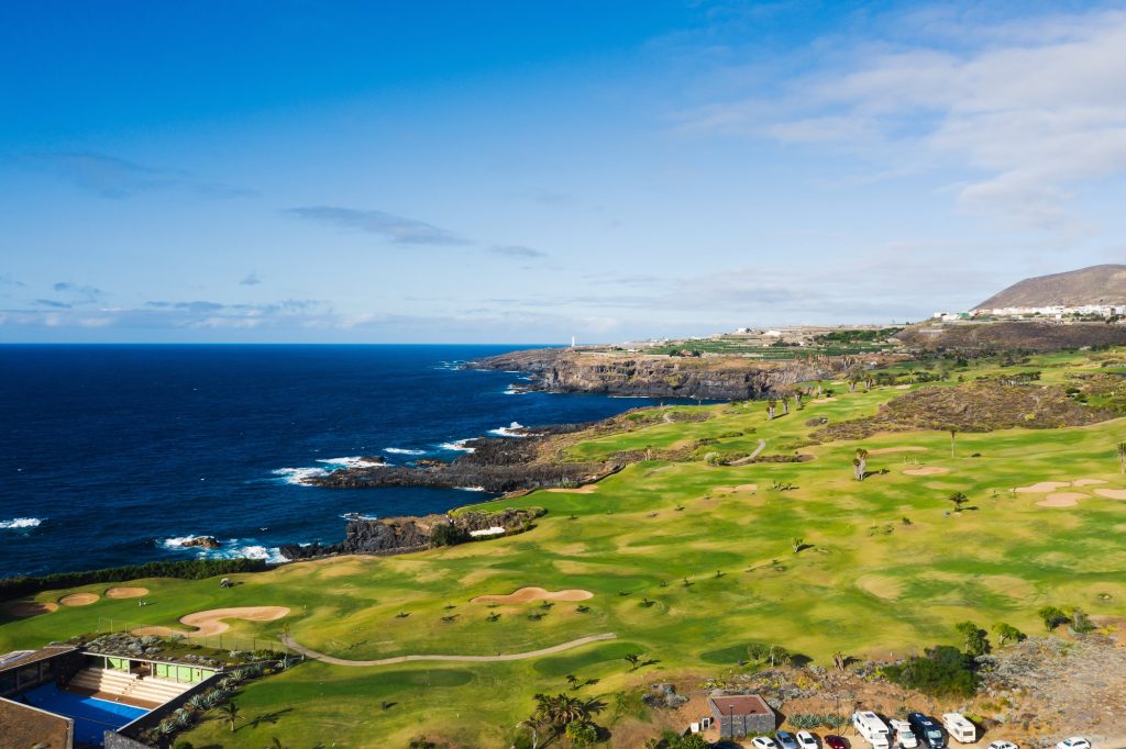 Golf course near the Atlantic ocean in Tenerife, Spain, green Golf course, tennis court in the nature of Tenerife