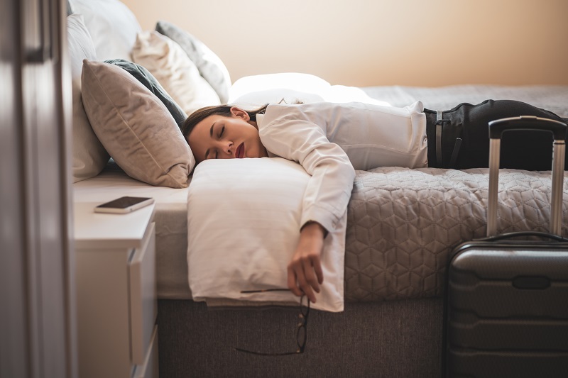 exhausted-businesswoman-sleeping-in-hotel-room