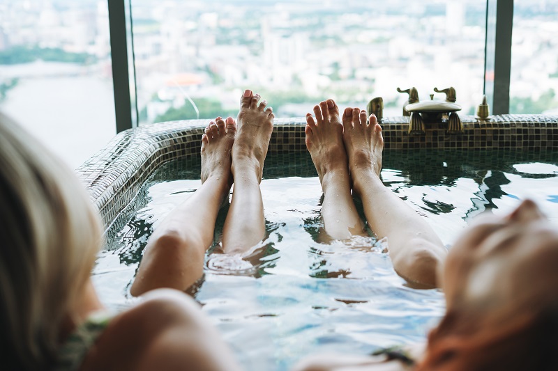 young-female-friends-take-bath-in-spa-hotel-in-fro