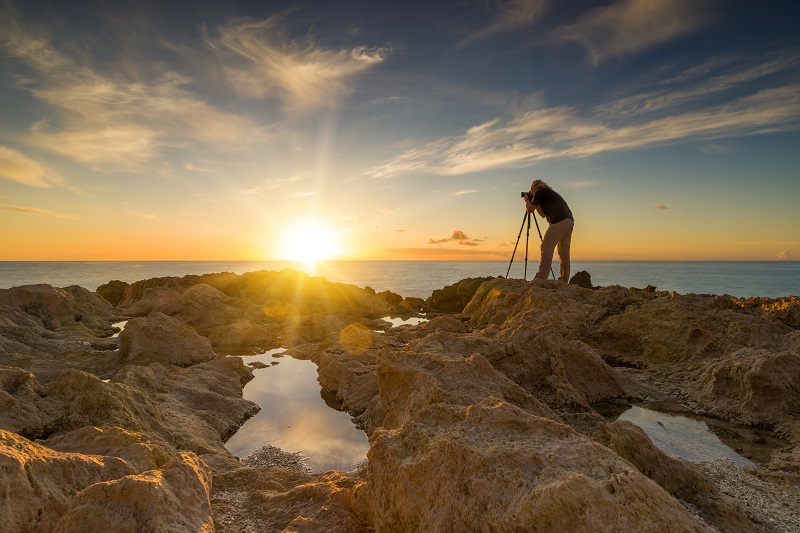 landscape photographer taking photos of the sunset