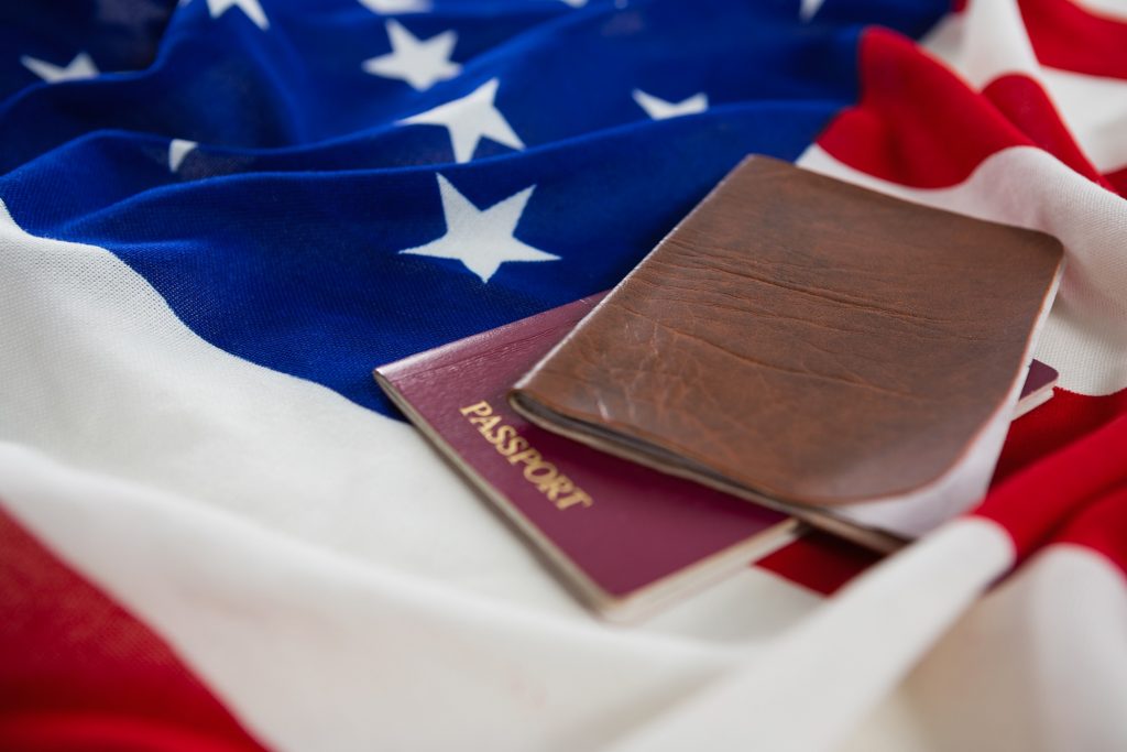 Close-up of passport and visa on an American flag