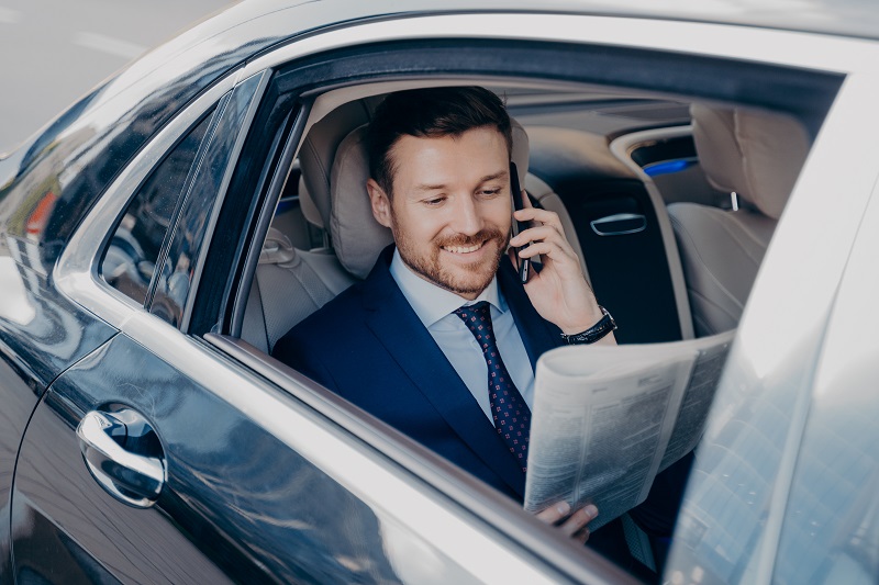 Elegant businessman in formal stylish wear traveling in luxury car