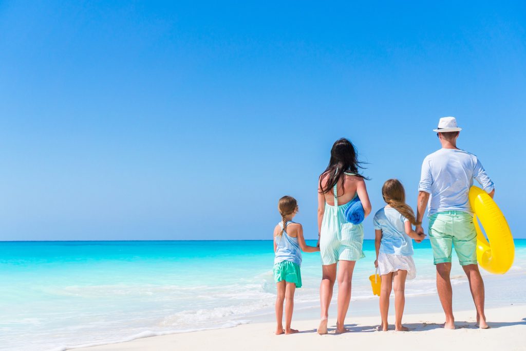 Young family on vacation on the beach. Family travel concept