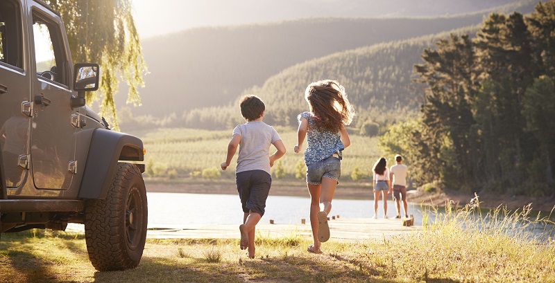 Excited Family Reaching Countryside Destination On Road Trip