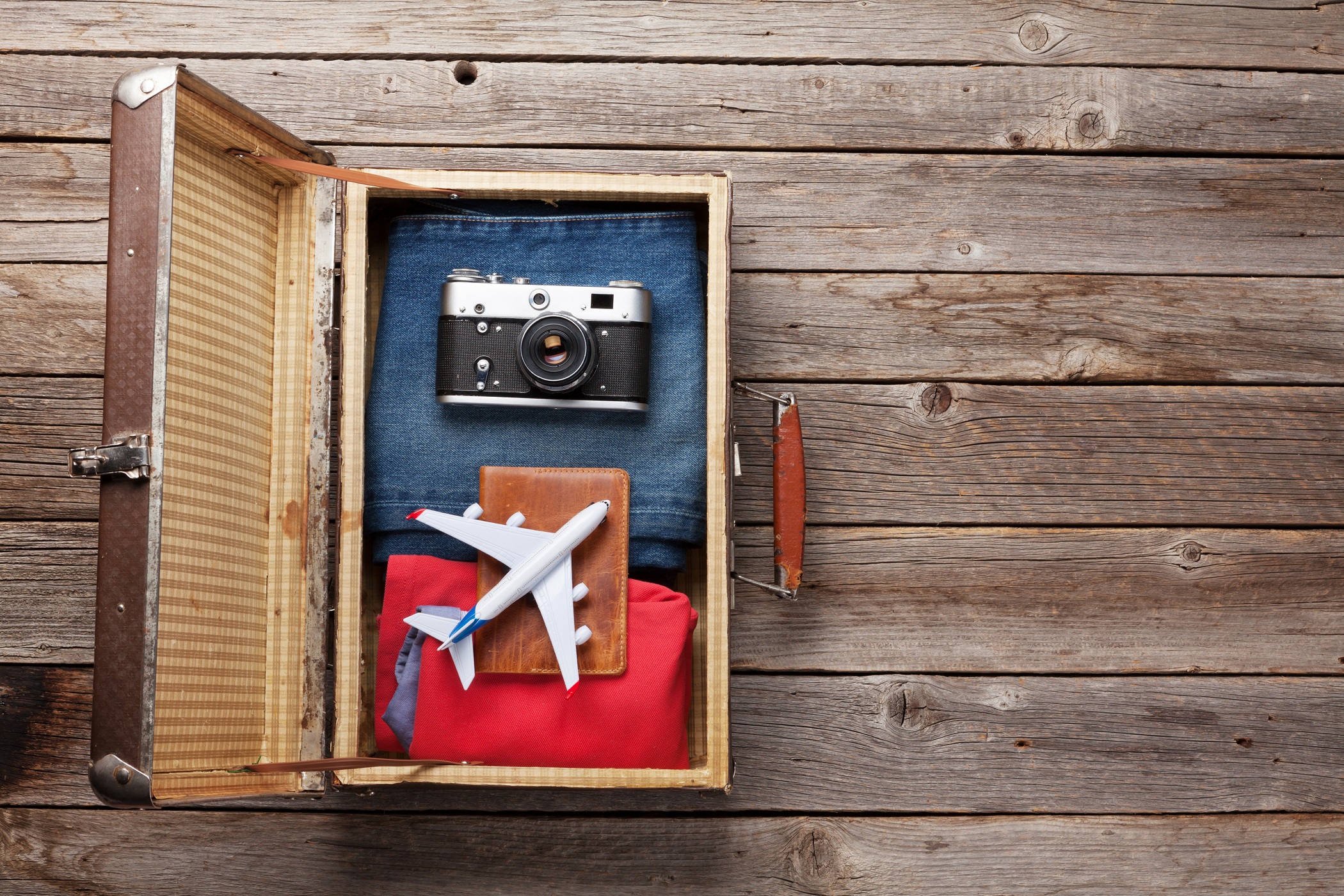 Topview of retro travel equipment on a wooden table. Vintage