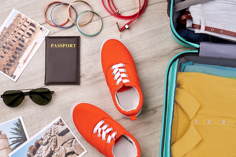 Travelling accessories on wooden floor.