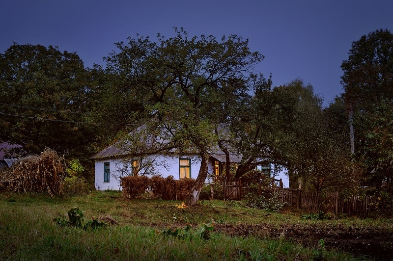 Old hut in village autumn evening scene