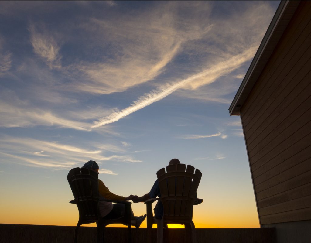 romantic-couple-silhouetted-on-porch-in-sunset