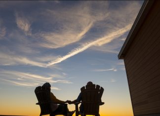 romantic-couple-silhouetted-on-porch-in-sunset