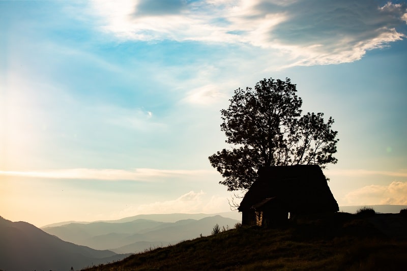 Sunset scene with cottage silhouette