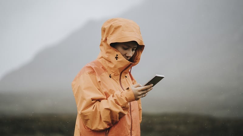 Woman using her mobile phone in the highlands