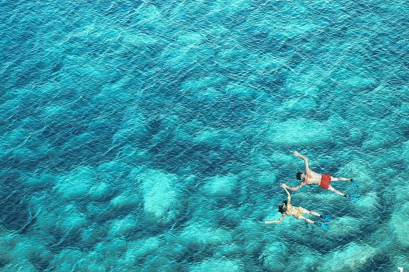 Above view of couple snorkeling in sea water
