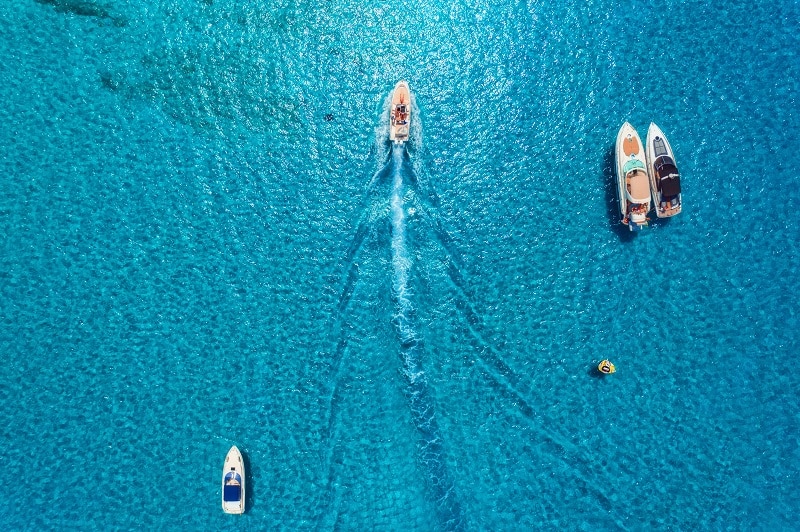 Aerial view of luxury yachts in transparent blue sea