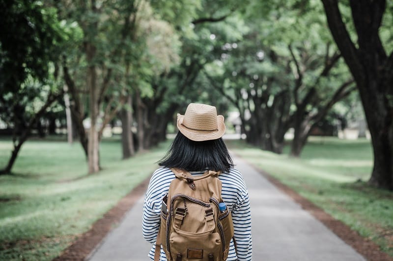 Asian woman backpack traveler use mobile take photo when traveli
