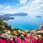 Lanscape,Of,Riviera,Coast,,Turquiose,Water,,Flowers,And,Blue,Sky