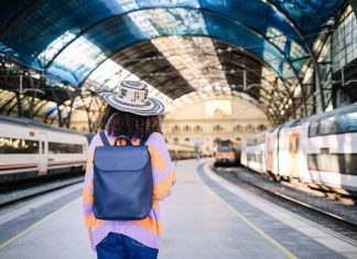 young-black-woman-traveler-with-backpack-and-hat-a