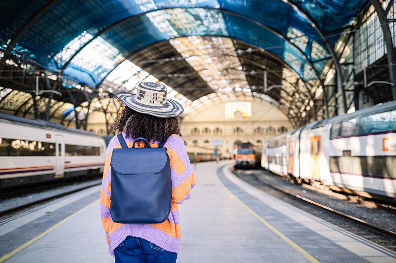 young-black-woman-traveler-with-backpack-and-hat-a