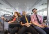 Businesswoman and men asleep on passenger ferry