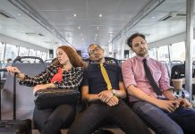 Businesswoman and men asleep on passenger ferry