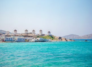 Famous view of traditional greek windmills on Mykonos island at sunrise, Cyclades, Greece